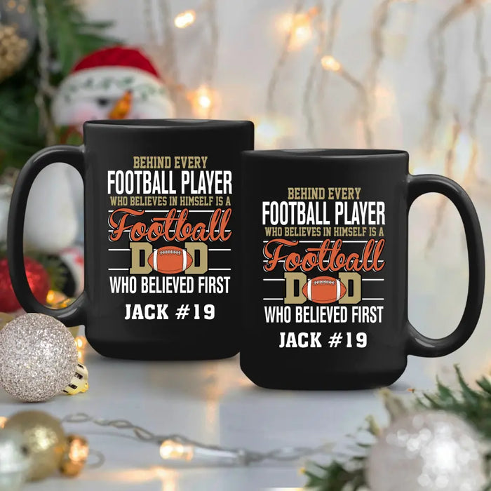 Personalized Behind Every Football Player Who Believes In Himself Is A Football Dad Who Believe First Mug, Custom Mug For Football Dad, Football Mom